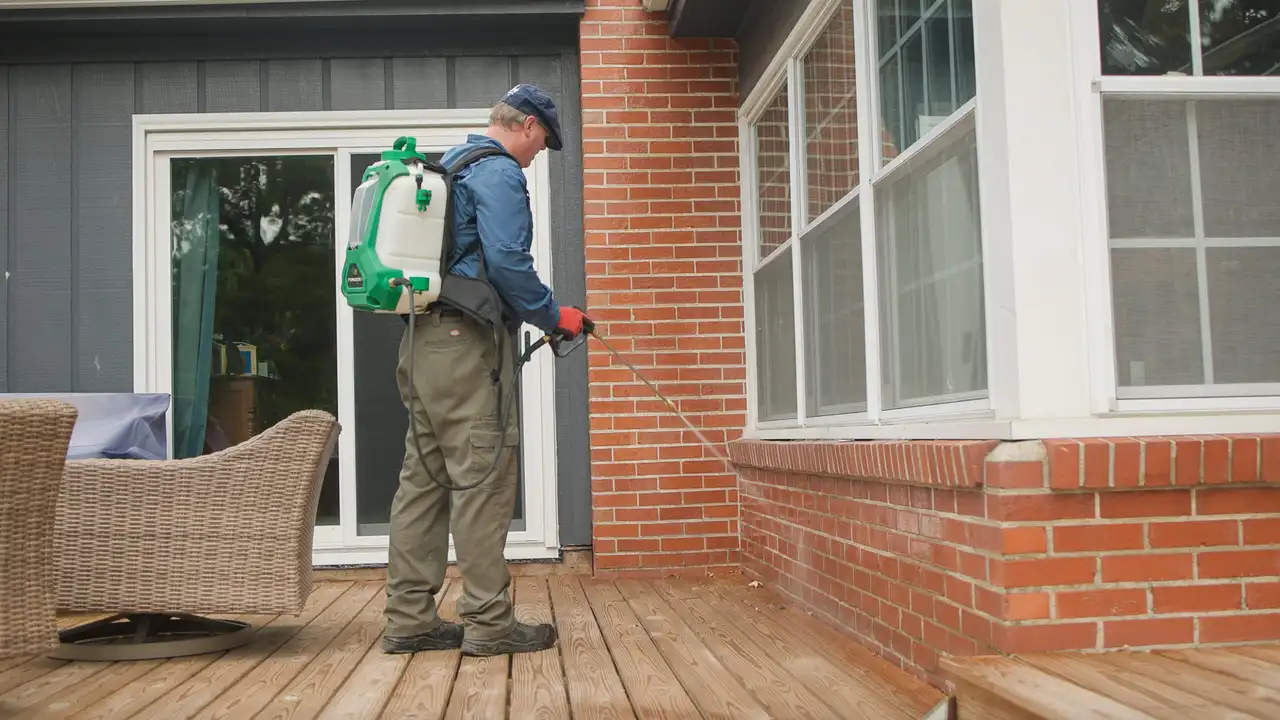 Bug Off technicians performing a general pest control treatment at a home